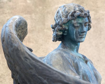 Bronze statue of angel on a tombstone