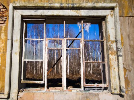 broken window in a wall of the collapsed house