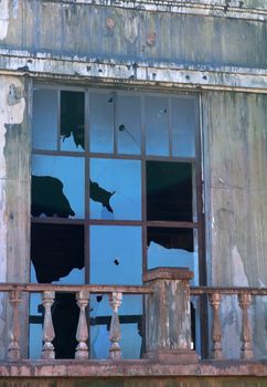 broken window in a wall of the collapsed house