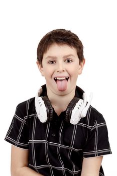 Young boy grinning and show tongue with headphones isolated on white background