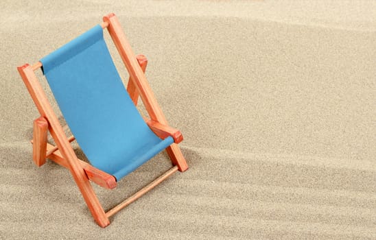 Vacation background with lounger in beach sand