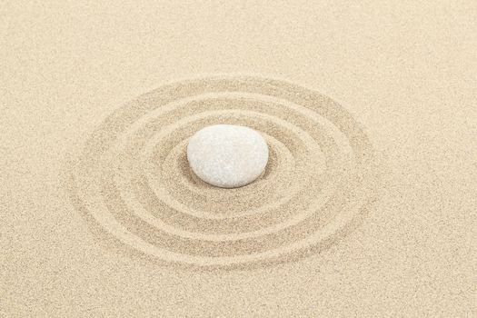 zen stones in soft sand with circles