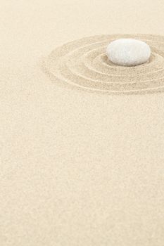 zen stones in soft sand with circles