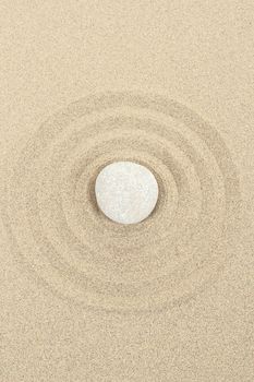 zen stones in soft sand with circles