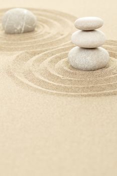 Balance of three zen stones in sand 
