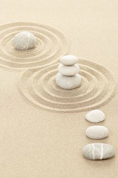 Balance of three zen stones in sand 