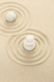 Balance of three zen stones in sand 