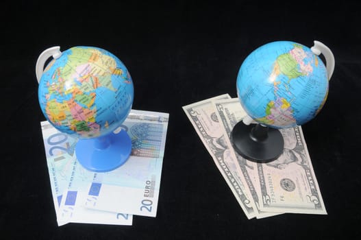 Round Globe and Money on a Dark Backgruond