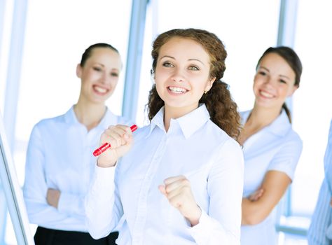 happy business woman standing next to their counterparts outside the flipchart achievements in business