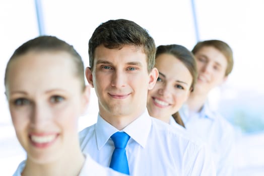 portrait of a young businessman standing in a row with his colleagues, concept of teamwork