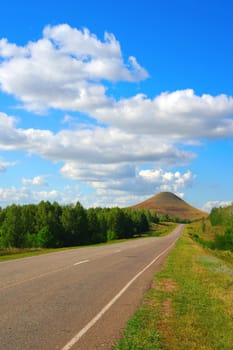 Beautiful summer landscape, road to high mountain, Blue sky with clouds