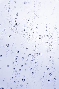 Drops of rain on the inclined window (glass). Shallow DOF.