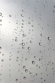 Drops of rain on the inclined window (glass). Shallow DOF.