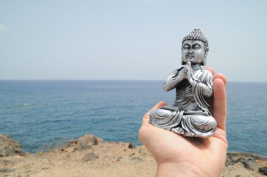 One Ancient Gray Buddha Statue Near The Ocean