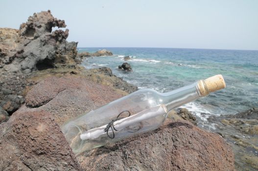 Message in the Bottle on the Rocks near the Beach