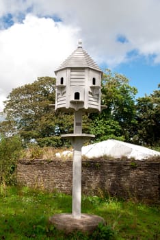 Image of a white dovecote in the country side.