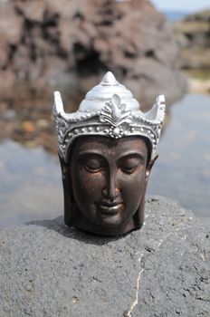 One Ancient Gray Buddha Statue Near The Ocean