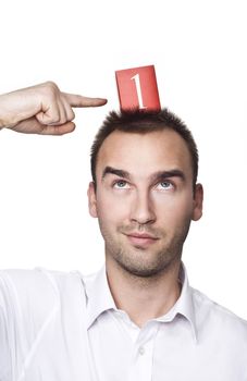 young male looking up and pointing his finger at number one