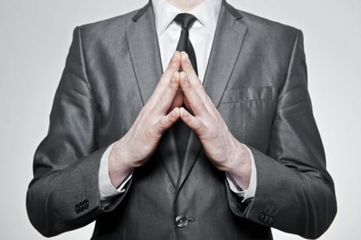 successfull businessman folding his hands together, over white background