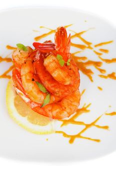 Delicious Fried Shrimps Decorated with Lemon, Mustard Sauce and Thyme closeup on White plate. Top View