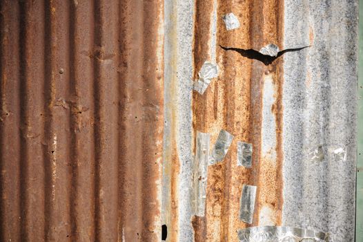 Old rusty zinc corrugated metal wall in old city.