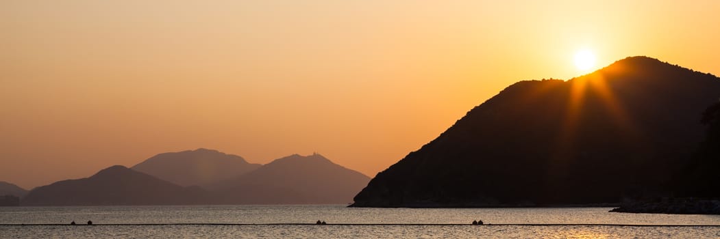 Sea and hills at sunset