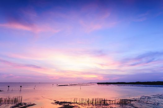 Beautiful twilight silhouette sunset at tropical sea in Thailand.