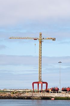 Photo of a crane at a cargo dock.