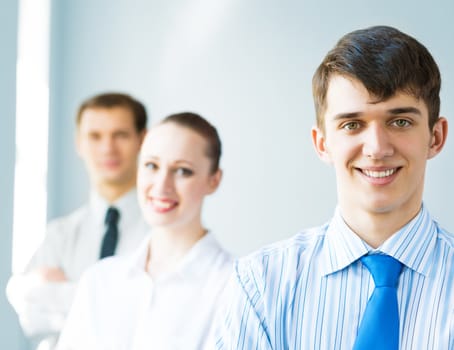 successful businessmen, a portrait of a businessman behind him are his colleagues