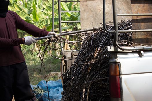 Thai people pull leftover of iron surplus in pickup truck