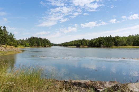 Lush green grass and trees, peaceful and serene waterways, and beautiful sky makes Maine a wonderful vacation destination.