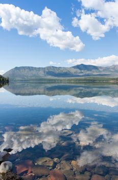 This is Glacier National Park in Montana with beautiful sky, land and water.