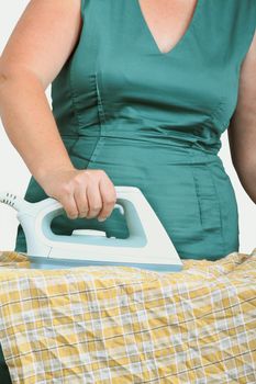 woman ironing clothes on ironing board