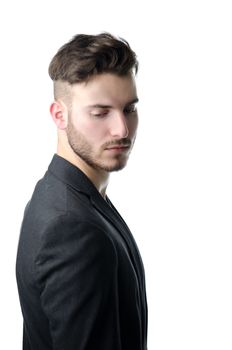 Attractive young business man looking down, serious expression, isolated on white