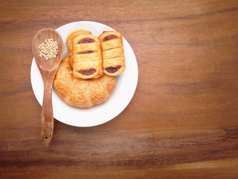 custard cake and croissant bread on white dish for multipurpose