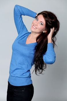 Beautiful young woman in gray background