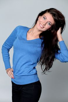 Beautiful young woman in gray background
