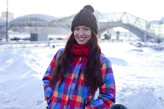 Portrait of a young woman on the background of a winter city