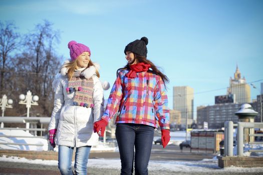 Happy young couple women in winter street