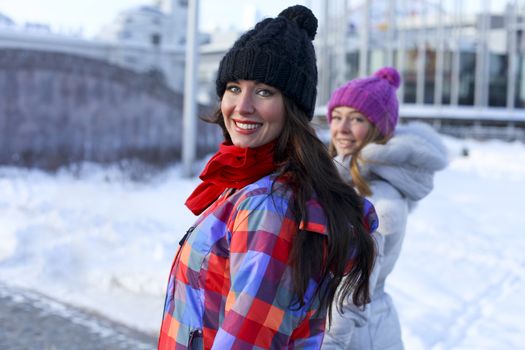 Happy young couple women in winter street