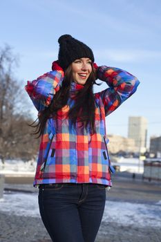 Portrait of a young woman on the background of a winter city
