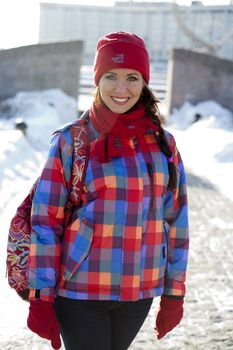 Portrait of a young woman on the background of a winter city