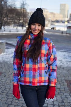 Portrait of a young woman on the background of a winter city