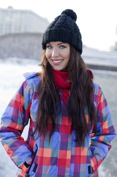 Portrait of a young woman on the background of a winter city