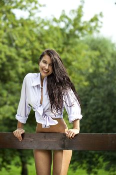 Sexy young Brunette in a summer park