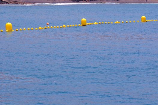 Some Yellow Floaters over the Blue of the Atlantic Ocean