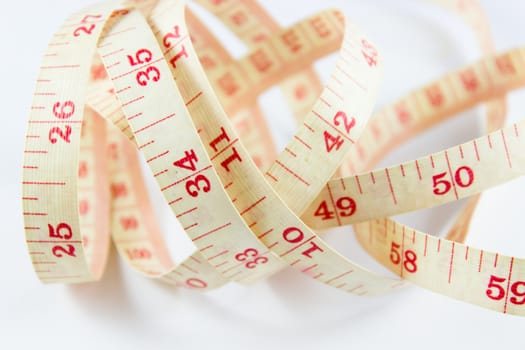 Old tape measure on rolled up on white background