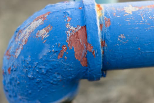 peeling paint on the side of a pipe