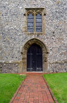 Solid oak wood arched door on the church of St Martin's Westmeston,Sussex,England.St Martin's was built between the 12th and 14th century.