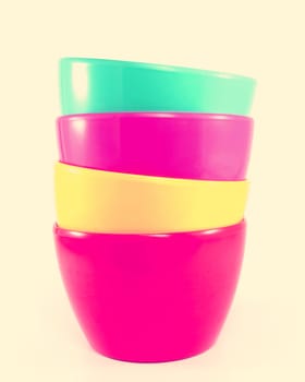 Stack of colorful plastic bowl with retro filter effect